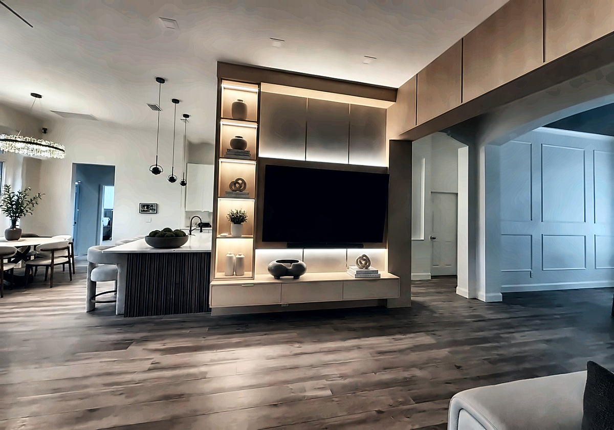 Kitchen and living area with a fluted island base and an illuminated display column